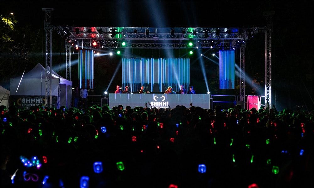 Stage with lights and an audience on headphones at a corporate event